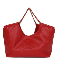 Chanel Small CC Cabas Hobo Bag, shown in dark red quilted shiny calfskin with a gold chain and interlocking logo.