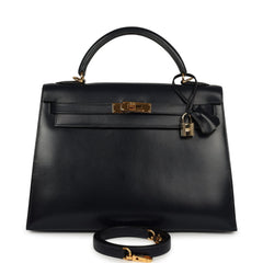 Vintage Hermès Kelly Sellier 32 Bleu Indigo Box Gold Hardware handbag, featuring a top handle, padlock, and shoulder strap.