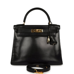 Vintage Hermes Kelly Retourne 28 Black Box Gold Hardware bag, shown with a top handle, padlock, and shoulder strap.