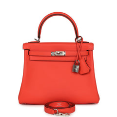 Hermès Kelly Retourne 25 in Orange Field Swift leather with palladium hardware, top handle, padlock, and detachable strap.