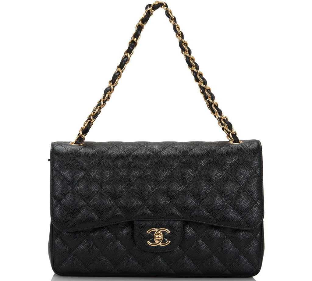 CHANEL. Classic bag with double flaps in black quilted l…
